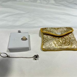 Pearl and silver tie tack.